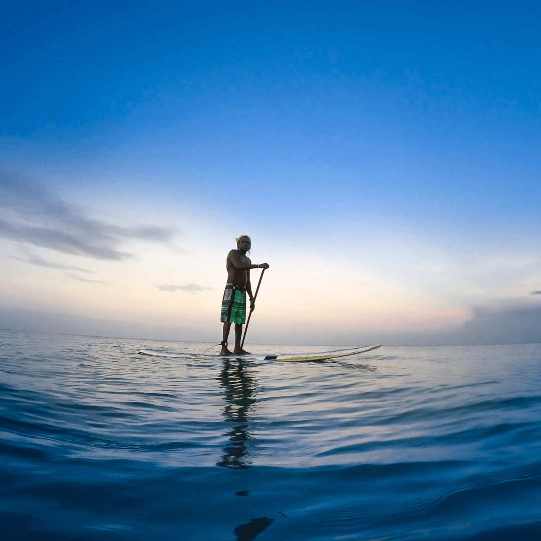 Man paddle boarding during a Fiji charter trip