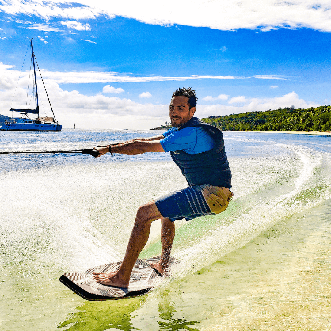 Man wake skating in Fiji during a charter trip