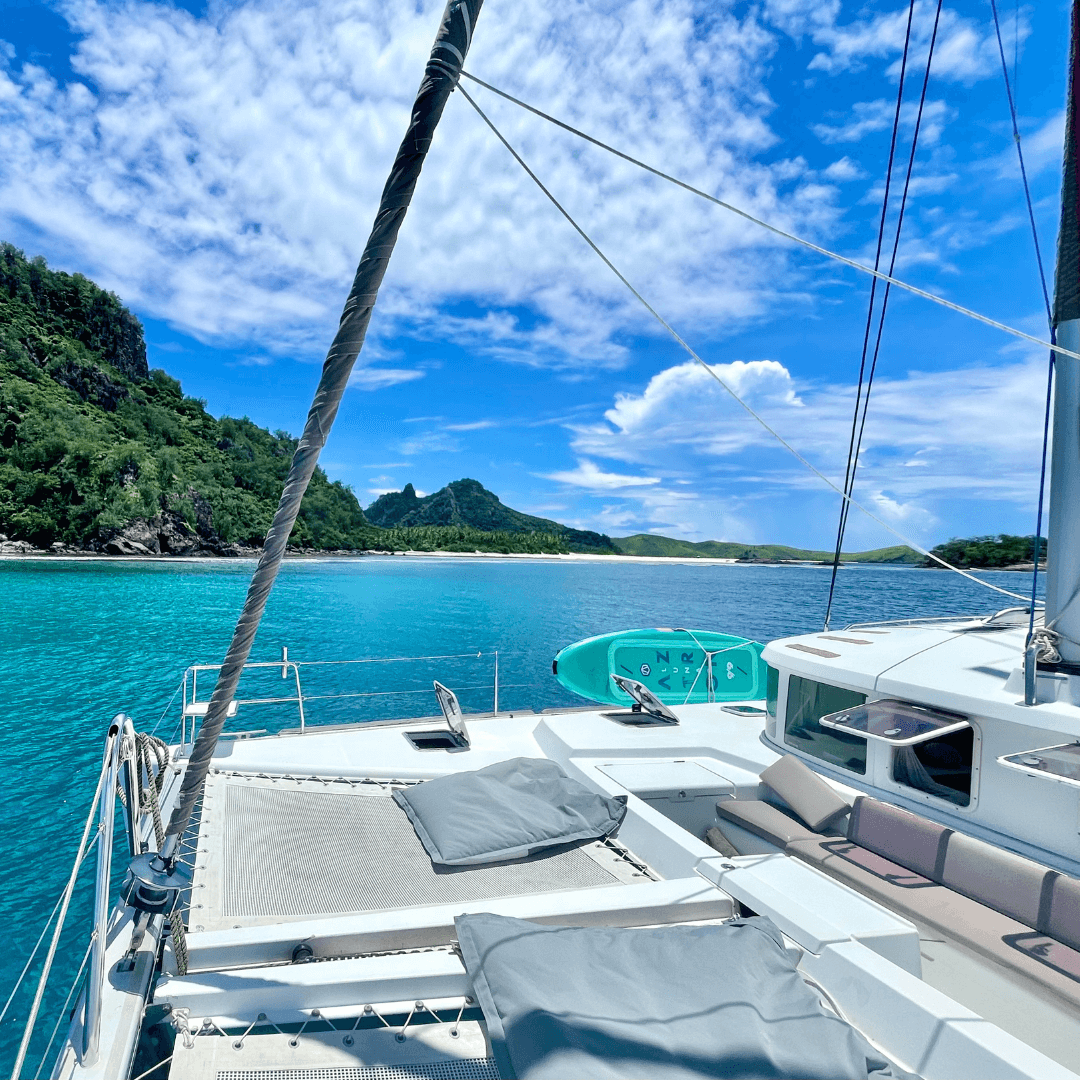 Bow of a catamaran with ample space for gathering and enjoying the ocean views.