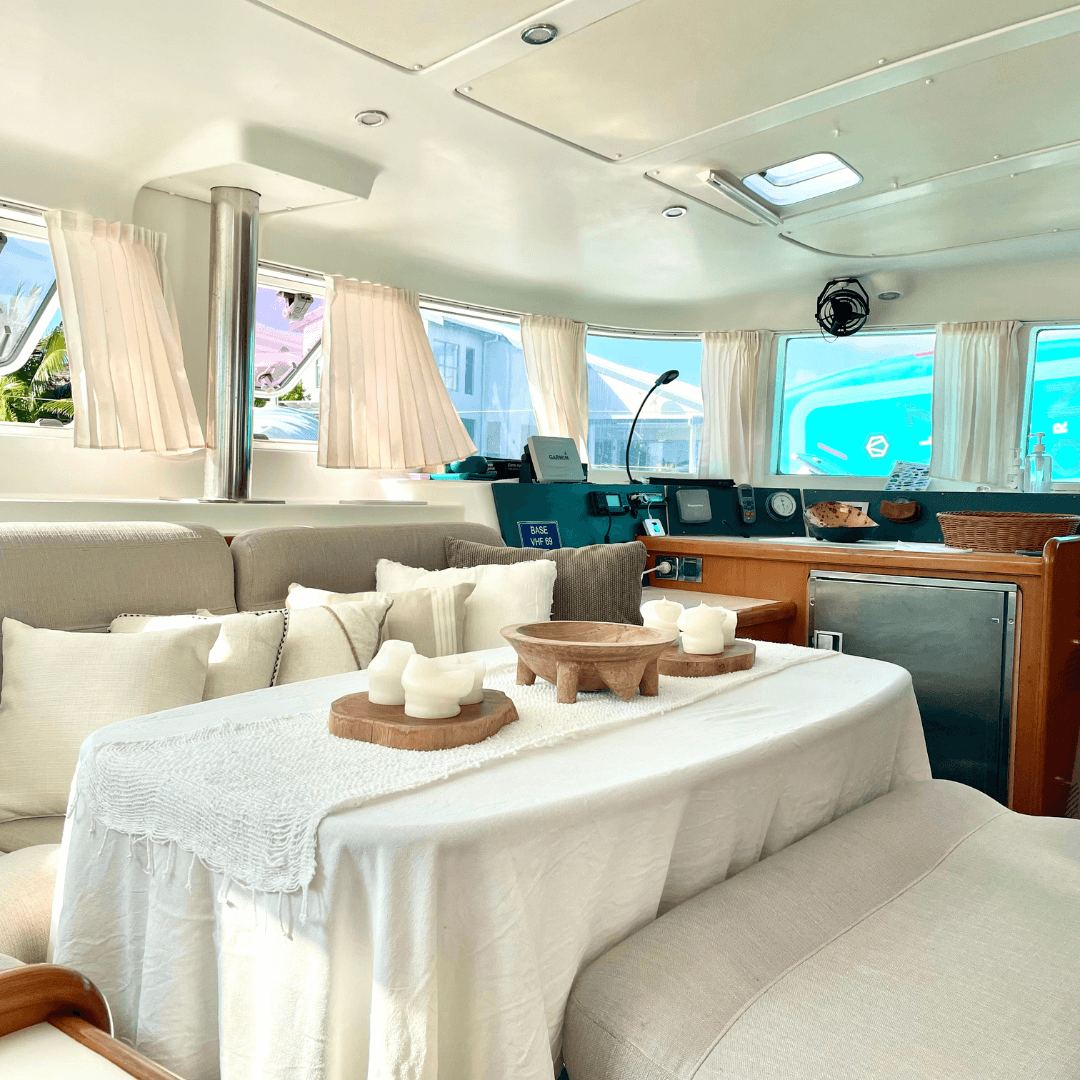 Interior view of a catamaran showing a well-equipped galley and inviting salon with soft furnishings