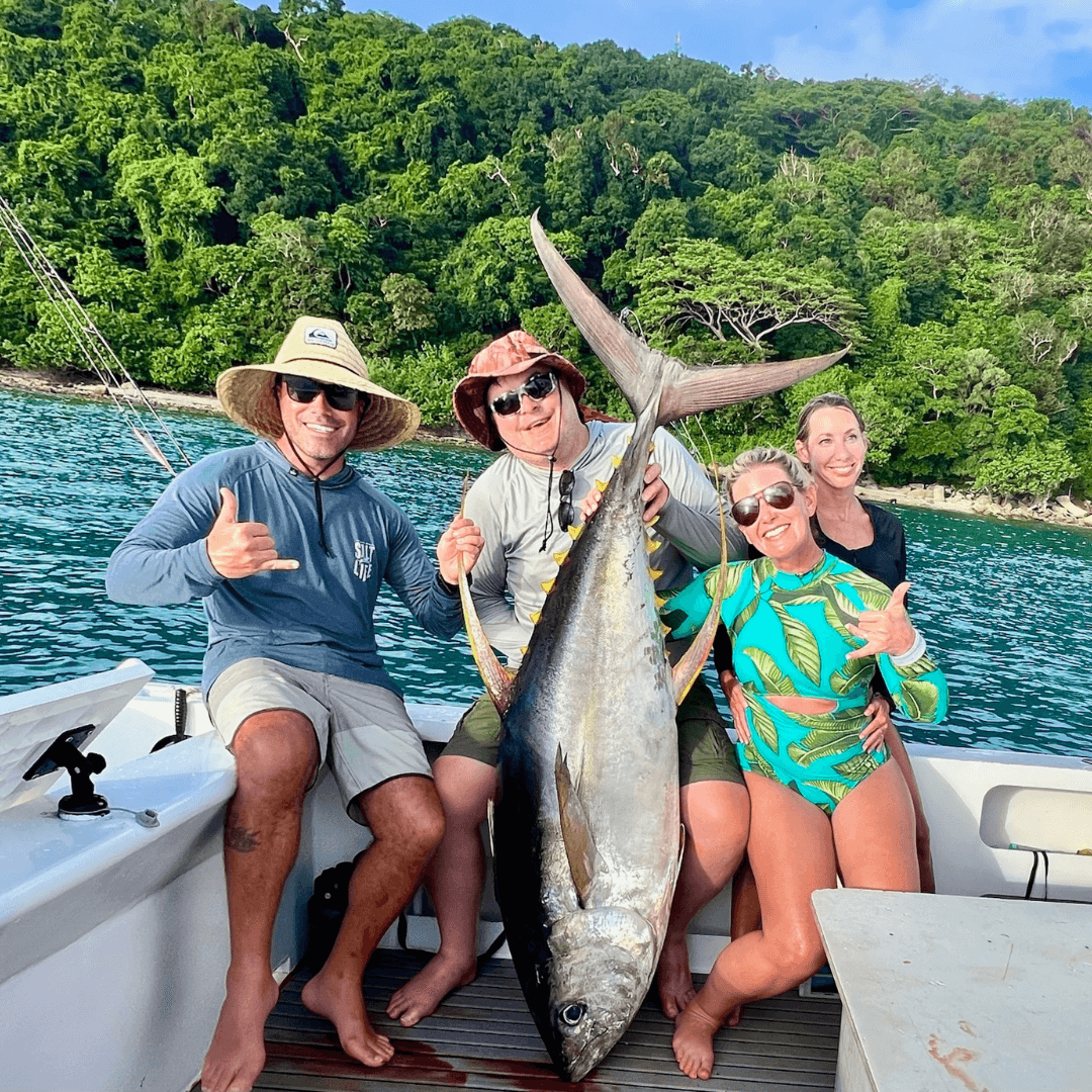 Man holding yellow fin tuna from trolling fishing technique