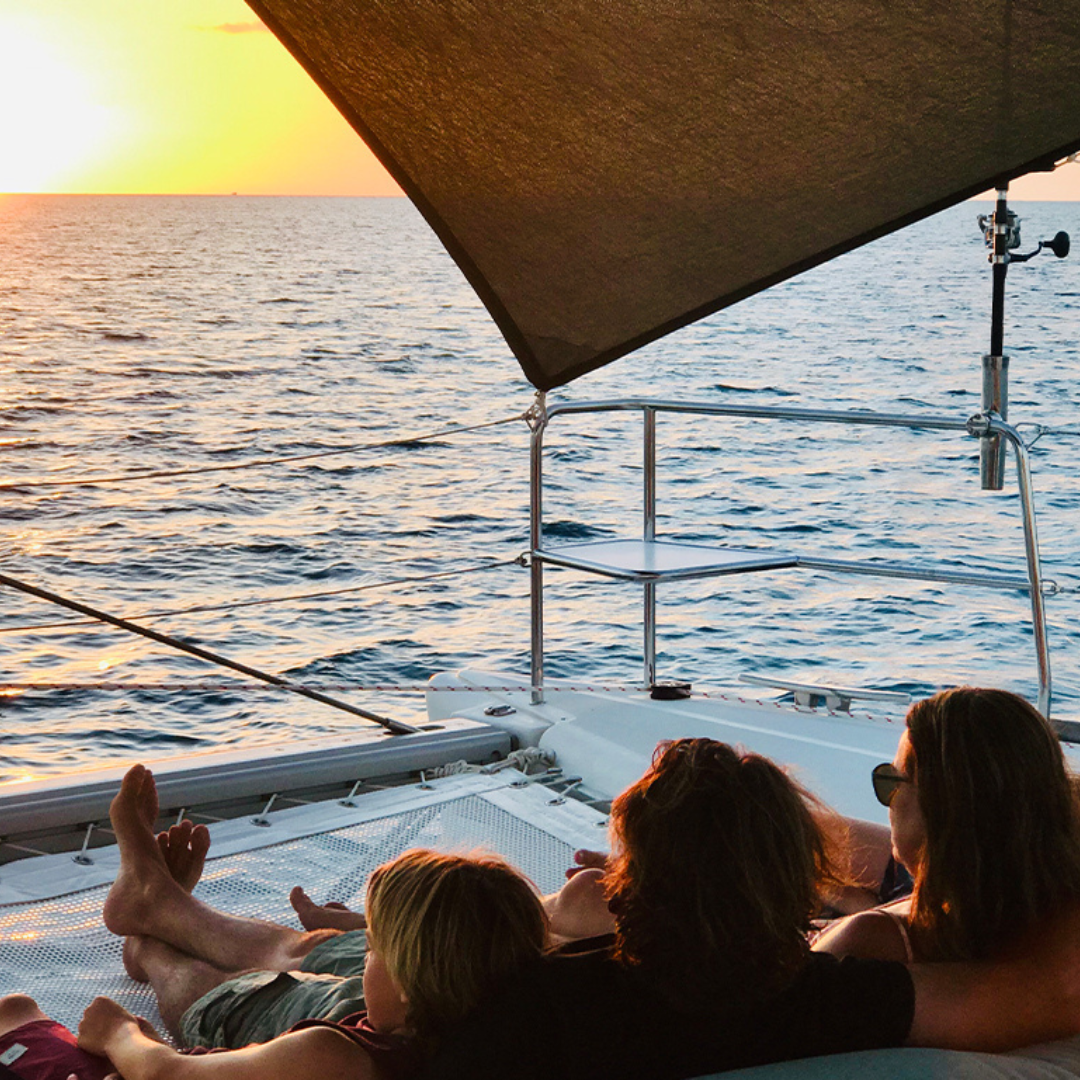 Parents and children enjoying the sunset on a Fiji boat charter